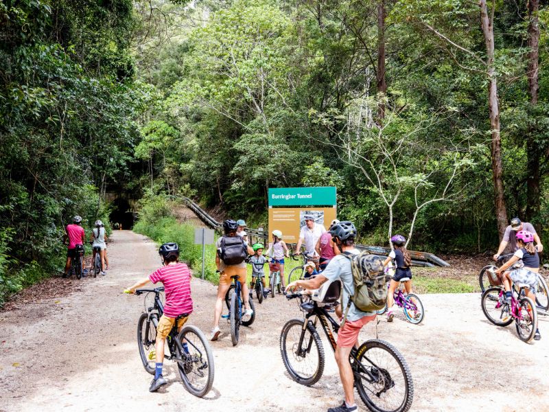 Bike riders at the entrance to the Burringbar Tunnel on the Northern Rivers Rail Trail